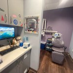 Exam room image with stuffed animals and cute stickers across the cabinets