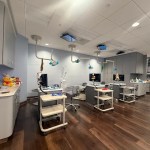 large exam room with three stations. tv's on the ceiling and little stuffed plushies throughout the room